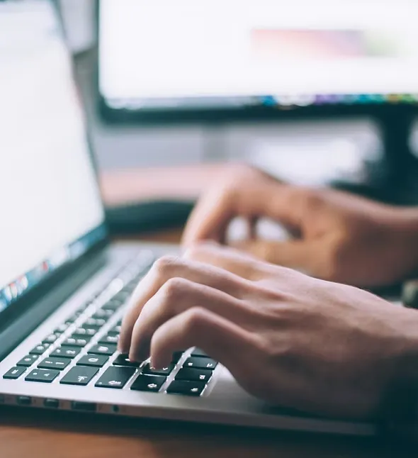 A hand up on the laptop keyboard - Amcharge offer consultancy & Feasibility Studies